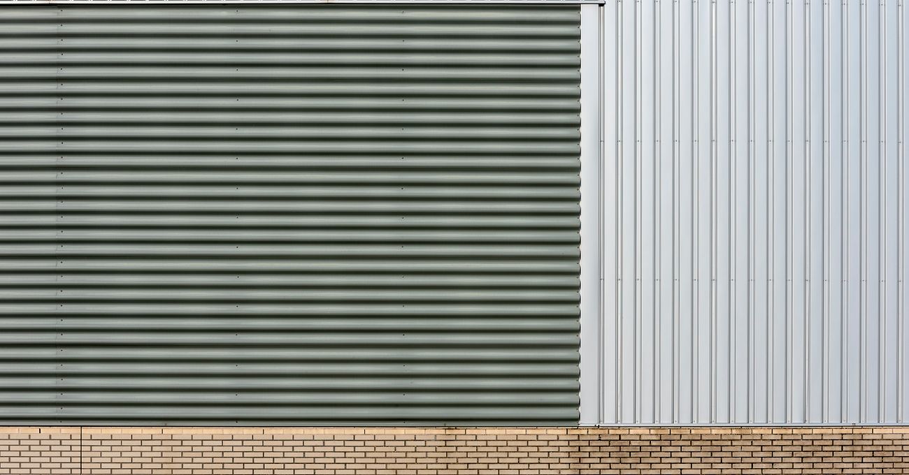 The metal and brick facade of an existing industrial building